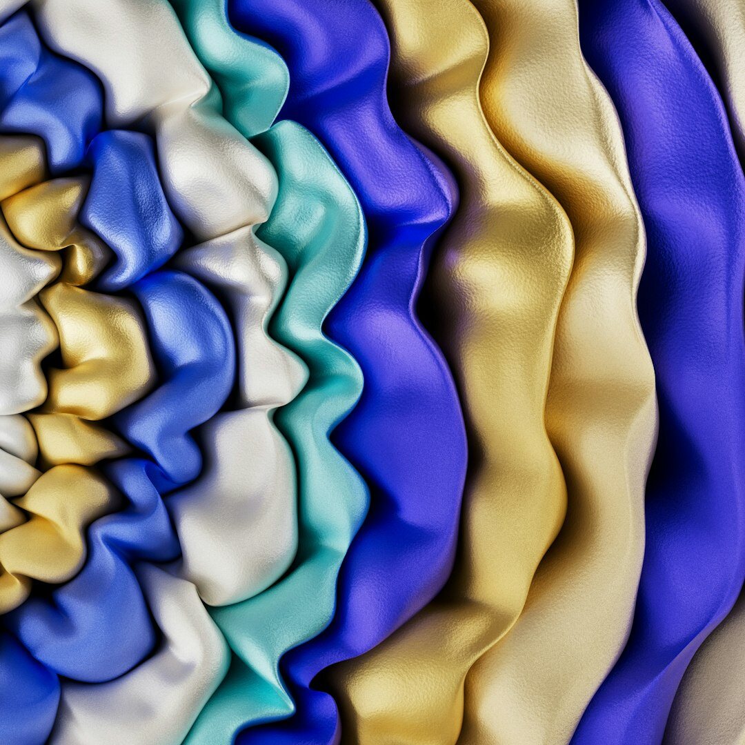 Close-up of gold jewelry and silk fabric texture